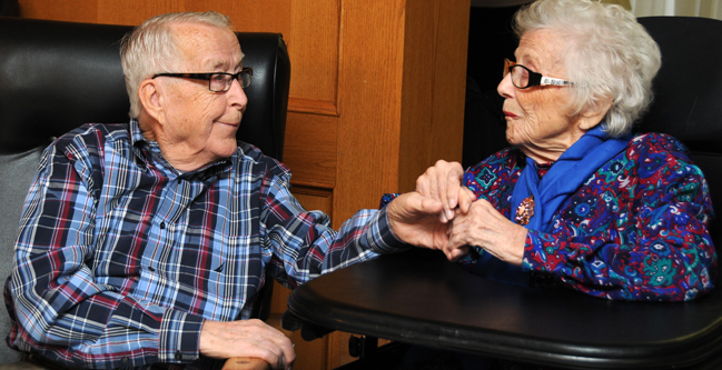 Marshall Bye enjoys some quality time with his wife of 60 years, Evelyn, in her Calgary long-term care facility.