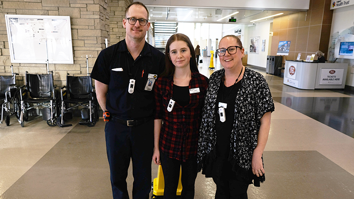 Andy and Michelle Johansen share a moment with their daughter Taylor, centre, at South Health Campus where they both work, during Take Our Kids to Work Day.