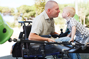 man in wheelchair with young boy