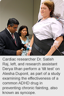 Cardiac researcher Dr. Satish Raj, left, and research assistant Derya Ilhan perform a ‘tilt test’ on Alesha Dupont, as part of a study examining the effectiveness of a common ADHD drug in preventing chronic fainting, also known as syncope.