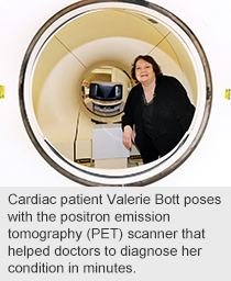 Cardiac patient Valerie Bott poses with the positron emission tomography (PET) scanner that helped doctors to diagnose her condition in minutes