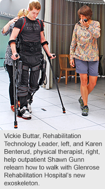 Vickie Buttar, Rehabilitation Technology Leader, left, and Karen Benterud, physical therapist, right, help outpatient Shawn Gunn relearn how to walk with Glenrose Rehabilitation Hospital’s new exoskeleton.