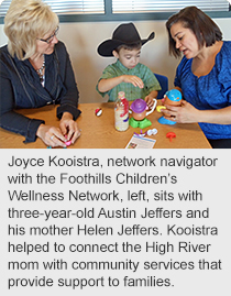 Joyce Kooistra, network navigator with the Foothills Children’s Wellness Network, left, sits with three-year-old Austin Jeffers and his mother Helen Jeffers. Kooistra helped to connect the High River mom with community services that provide support to families.