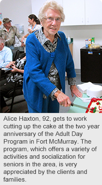 Alice Haxton, 92, is joined by home support aide Wendy Groulx as she gets to work cutting up the cake at the two year anniversary of the Adult Day Program in Fort McMurray. The program, which offers a variety of activities and socialization for seniors in the area, is very appreciated by the clients and families.