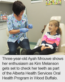 Three-year-old Ayah Mrouwe shows her enthusiasm as Kim Melanson gets set to check her teeth as part of the Alberta Health Services Oral Health Program in Wood Buffalo