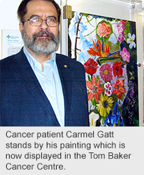 Cancer patient Carmel Gatt stands by his painting which is now displayed in the Tom Baker Cancer Centre.