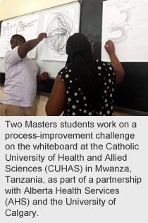 Two Masters students work on a process-improvement challenge on the whiteboard at the Catholic University of Health and Allied Sciences (CUHAS) in Mwanza, Tanzania, as part of a partnership with Alberta Health Services (AHS) and the University of Calgary.