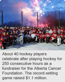 About 40 hockey players celebrate after playing hockey for 250 consecutive hours as a fundraiser for the Alberta Cancer Foundation. The record-setting game raised $1.1 million.