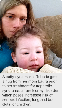 A puffy-eyed Hazel Roberts gets a hug from her mom Laura prior to her treatment for nephrotic syndrome, a rare kidney disorder which poses increased risk of serious infection, lung and brain clots for children.