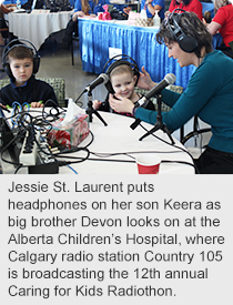 Jessie St. Laurent puts headphones on her son Keera as big brother Devon looks on at the Alberta Children’s Hospital, where Calgary radio station Country 105 is broadcasting the 12th annual Caring for Kids Radiothon