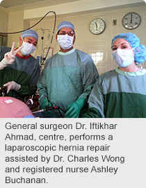 General surgeon Dr. Iftikhar Ahmad, centre, performs a laparoscopic hernia repair assisted by Dr. Charles Wong and registered nurse Ashley Buchanan.
