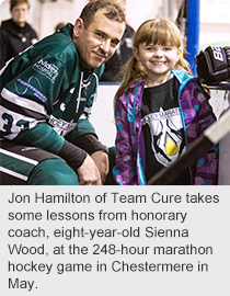 Jon Hamilton of Team Cure takes some lessons from honorary coach, eight-year-old Sienna Wood, at the 248-hour marathon hockey game in Chestermere in May.