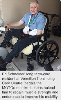 Ed Schneider, long term-care resident at Vermilion Continuing Care Centre, pedals the MOTOmed bike that has helped him to regain muscle strength and endurance to improve his mobility.