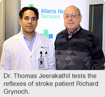 Dr. Thomas Jeerakathil tests the reflexes of stroke patient Richard Grynoch.