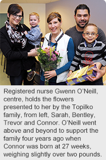 Registered nurse Gwenn O’Neill, centre, holds the flowers presented to her by the Topilko family, from left, Sarah, Bentley, Trevor and Connor. O’Neill went above and beyond to support the family four years ago when Connor was born at 27 weeks, weighing slightly over two pounds.