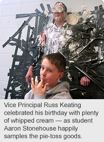 Vice Principal Russ Keating celebrated his birthday with plenty of whipped cream — as student Aaron Stonehouse happily samples the pie-toss goods.