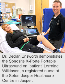 Dr. Declan Unsworth demonstrates the Sonosite X-Porte Portable Ultrasound on ‘patient’ Lorraine Wilkinson, a registered nurse at the Seton-Jasper Healthcare Centre in Jasper