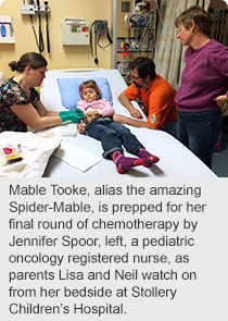 Mable Tooke, alias the amazing Spider-Mable, is prepped for her final round of chemotherapy by Jennifer Spoor, left, a pediatric oncology registered nurse, as parents Lisa and Neil watch on from her bedside at Stollery Children’s Hospital.