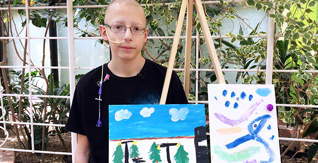 Stollery patient Devin Nahirnak,15, shows off two of his submissions for A Journey Through the Stollery, an art show that traces a child’s journey through the hospital with works created by patients and their families.