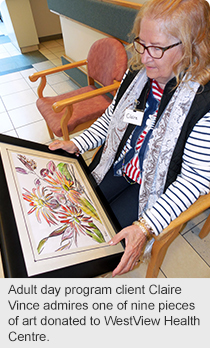 Adult day program client Claire Vince admires one of nine pieces of art donated to WestView Health Centre.  