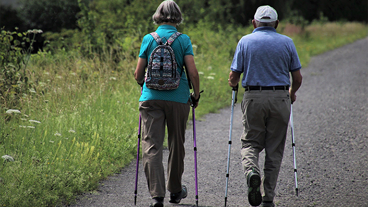 two people walking down road