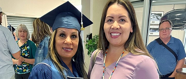 Amanda Merrier, left, and Leona Small, a senior advisor with the Indigenous Talent Acquisition team, share smiles at Merrier’s graduation ceremony.