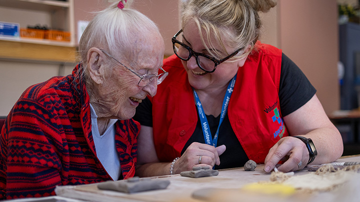 Cori MacGregor, right, shares a laugh with Irene McNeil as they work together on a clay creation.