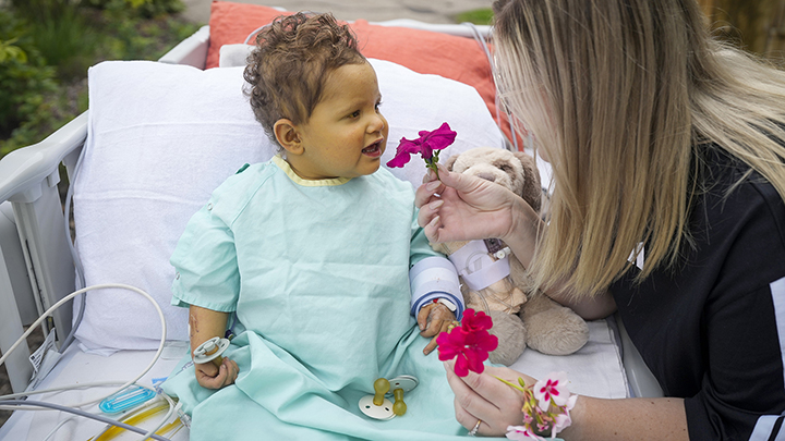 Colby takes in the bouquet of his Mom's flower in the Calgary sunshine.
