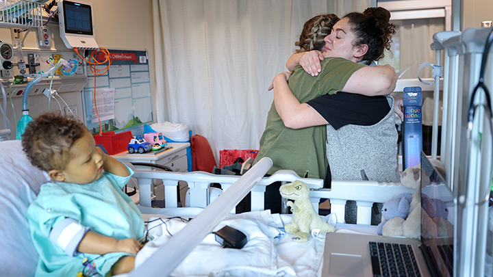 Stephanie Croft, left, hugs Dr. Alexa Scarcello moments before Colby leaves ACH for a flight to the Stollery Children's Hospital for a liver transplant.