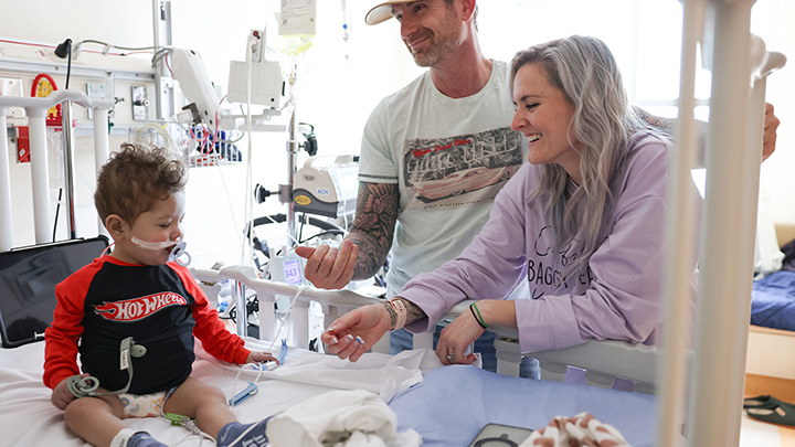 Colby gets a visit post-surgery from donor Amy and her husband Sean.
