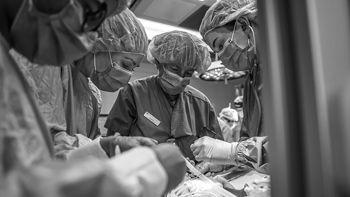 Shortly after birth, a neonatal team begins the delicate work of stabilizing one of the twins in the OR at Foothills Medical Centre.