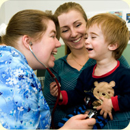 Nurse with child and mom laughing