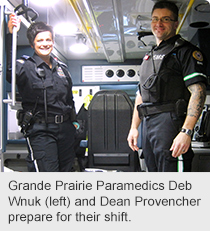 Grande Prairie Paramedics Deb Wnuk (left) and Dean Provencher prepare for their shift.