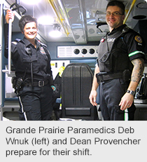 Grande Prairie Paramedics Deb Wnuk (left) and Dean Provencher prepare for their shift.