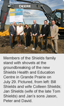 Shields family stand with shovels