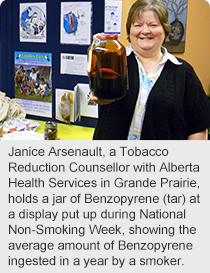 Janice Arsenault, a Tobacco Reduction Counsellor with Alberta Health Services in Grande Prairie, holds a jar of Benzopyrene (tar) at a display put up during National Non-Smoking Week, showing the average amount of Benzopyrene ingested in a year by a smoker. 