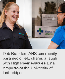 Deb Branden, AHS community paramedic, left, shares a laugh with High River evacuee Elna Ampusta at the University of Lethbridge.