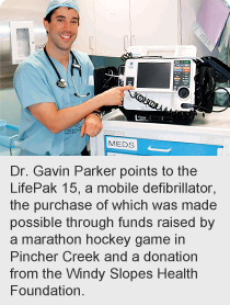 Dr. Gavin Parker points to the LifePak 15, a mobile defibrillator, the purchase of which was made possible through funds raised by a marathon hockey game in Pincher Creek and a donation from the Windy Slopes Health Foundation.