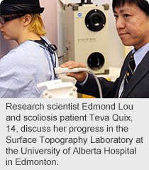Research scientist Edmond Lou and scoliosis patient Teva Quix, 14, discuss her progress in the Surface Topography Laboratory at the University of Alberta Hospital in Edmonton