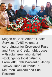 Megan deBoer, Alberta Health Services (AHS) volunteer co-ordinator for Crowsnest Pass and Pincher Creek, right, poses with volunteers who stuffed stockings for local patients. 