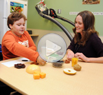 Dawn Hersey, left, watches her son, Brandon McMeckan, work with AHS registered dietitian Janelle Stefanyk 