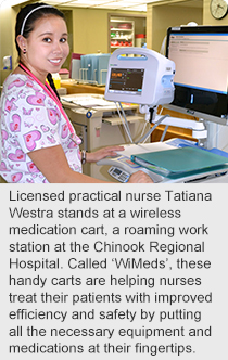 Licensed practical nurse Tatiana Westra stands at a wireless medication cart, a roaming work station at the Chinook Regional Hospital. 