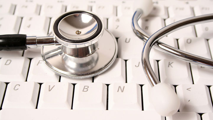 stock image of a stethoscope on a keyboard
