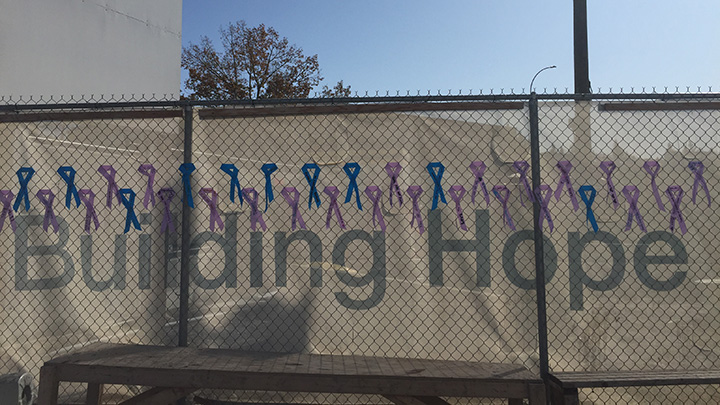 Support ribbons tied on fence with the words Building Hope