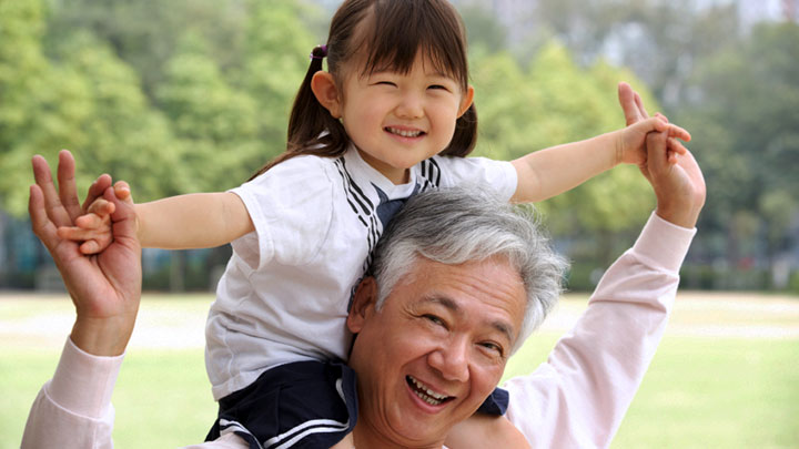 Little girl on her grandpa's shoulders