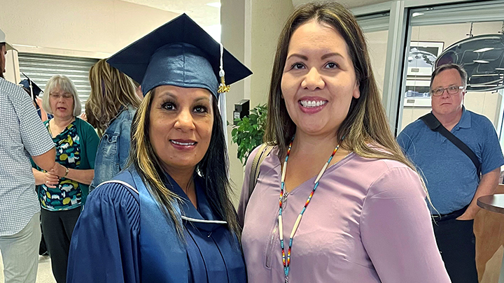 Amanda Merrier, left, and Leona Small, a senior advisor with the Indigenous Talent Acquisition team, share smiles at Merrier’s graduation ceremony.