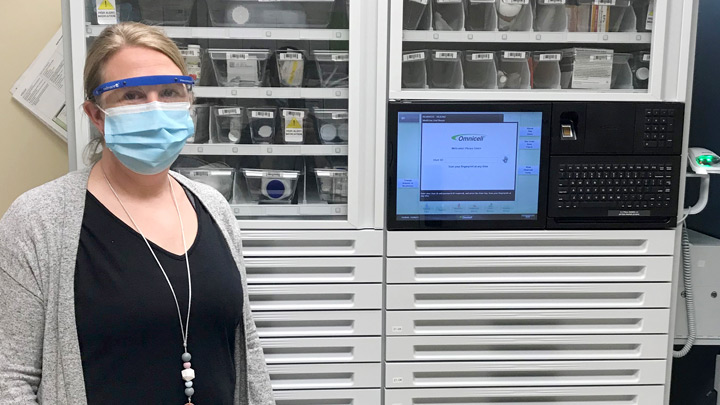 Amy McMorran, pharmacy manager for Northern Lights Regional Health Centre, poses in front of one of the facility’s new Omnicell automated medication dispensing cabinets.