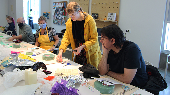 Guest artist Arianna Richardson, standing, a Lethbridge sculptor and performance artist, leads a workshop in A Brush With Art on making flowers from discarded plastic waste.