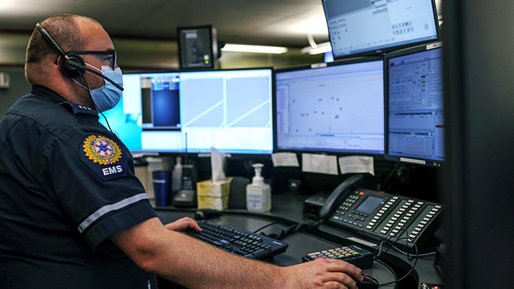 Justin Squires, an Emergency Communications Officer in Calgary, takes a call. After a decade-long initiative, EMS dispatch services across the province — with the recent addition of Calgary, Lethbridge, Red Deer and the Municipality of Wood Buffalo — are now consolidated under the AHS umbrella.