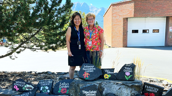 Volunteers Michiko Ellis, left, Rose Chobaniuk hand-painted each sign for the Canmore Hospital Gardens.